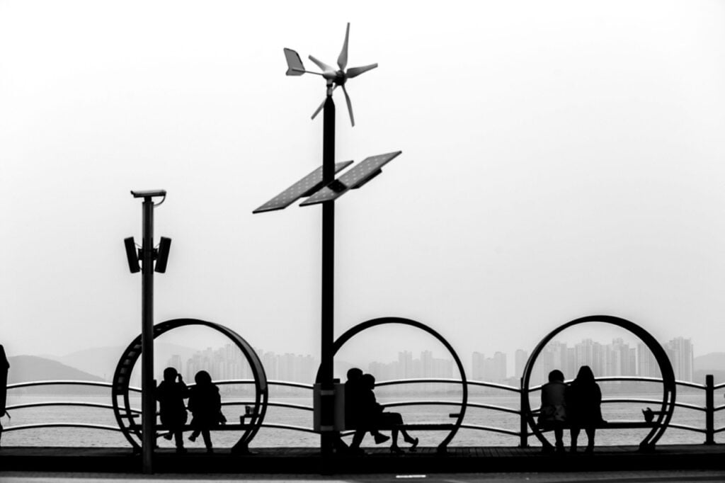 Group of people sitting in pairs in a park on the beach, symbolizing unity and connection. Sympathy, Empathy, Compassion